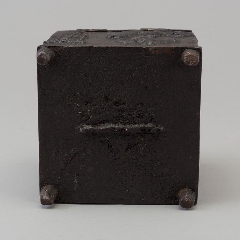 An empire cast iron tobacco box, dated 1838.