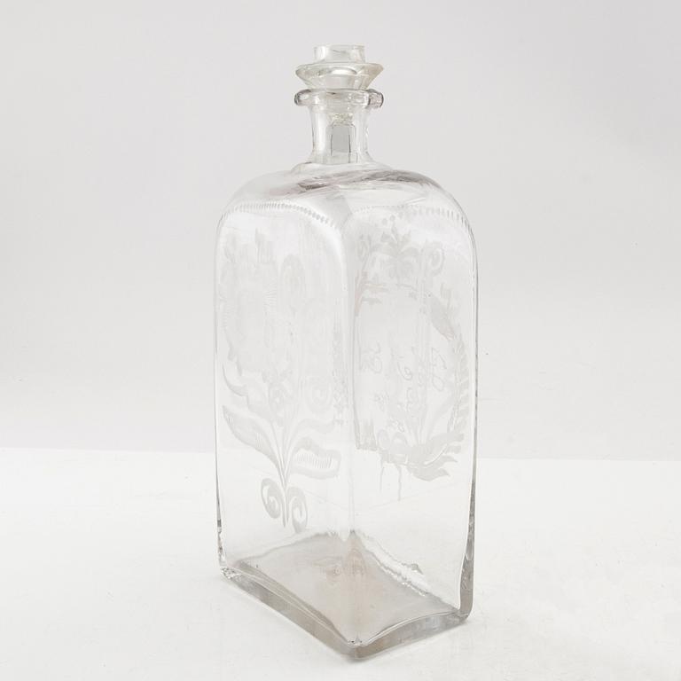 Brännvinsflaska, glas. Daterad Broby 1856.