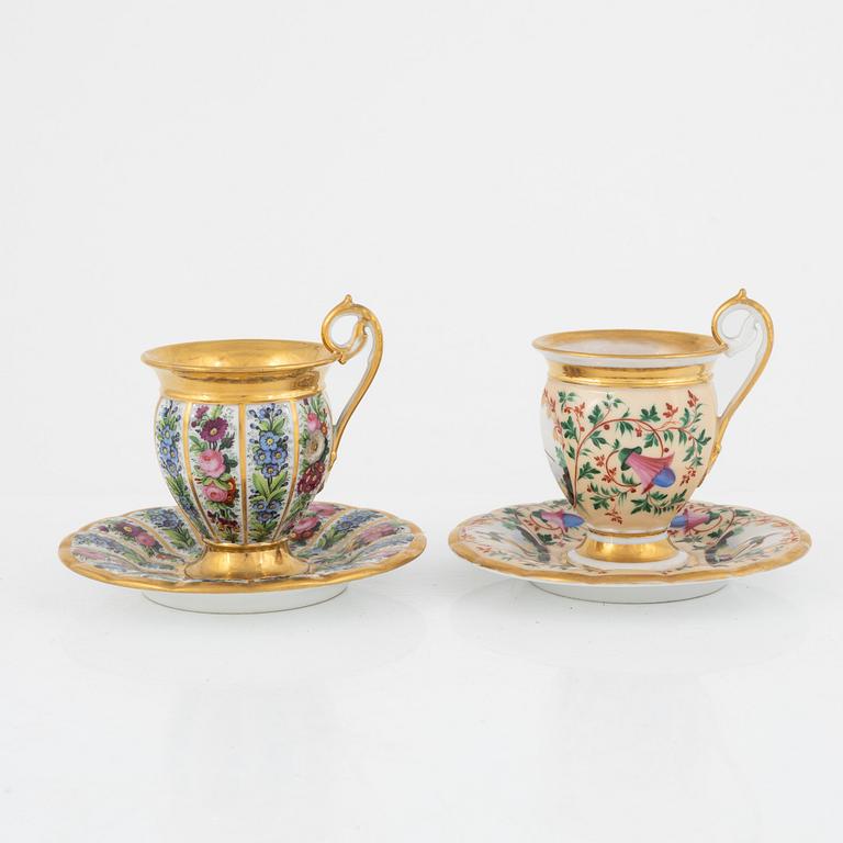 Two Empire porcelain cups with stands, 19th century.