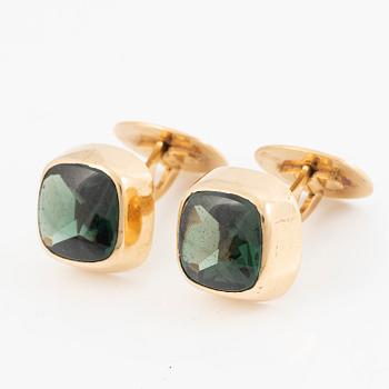 Ett par manschettknappar 18K guld med gröna stenar.