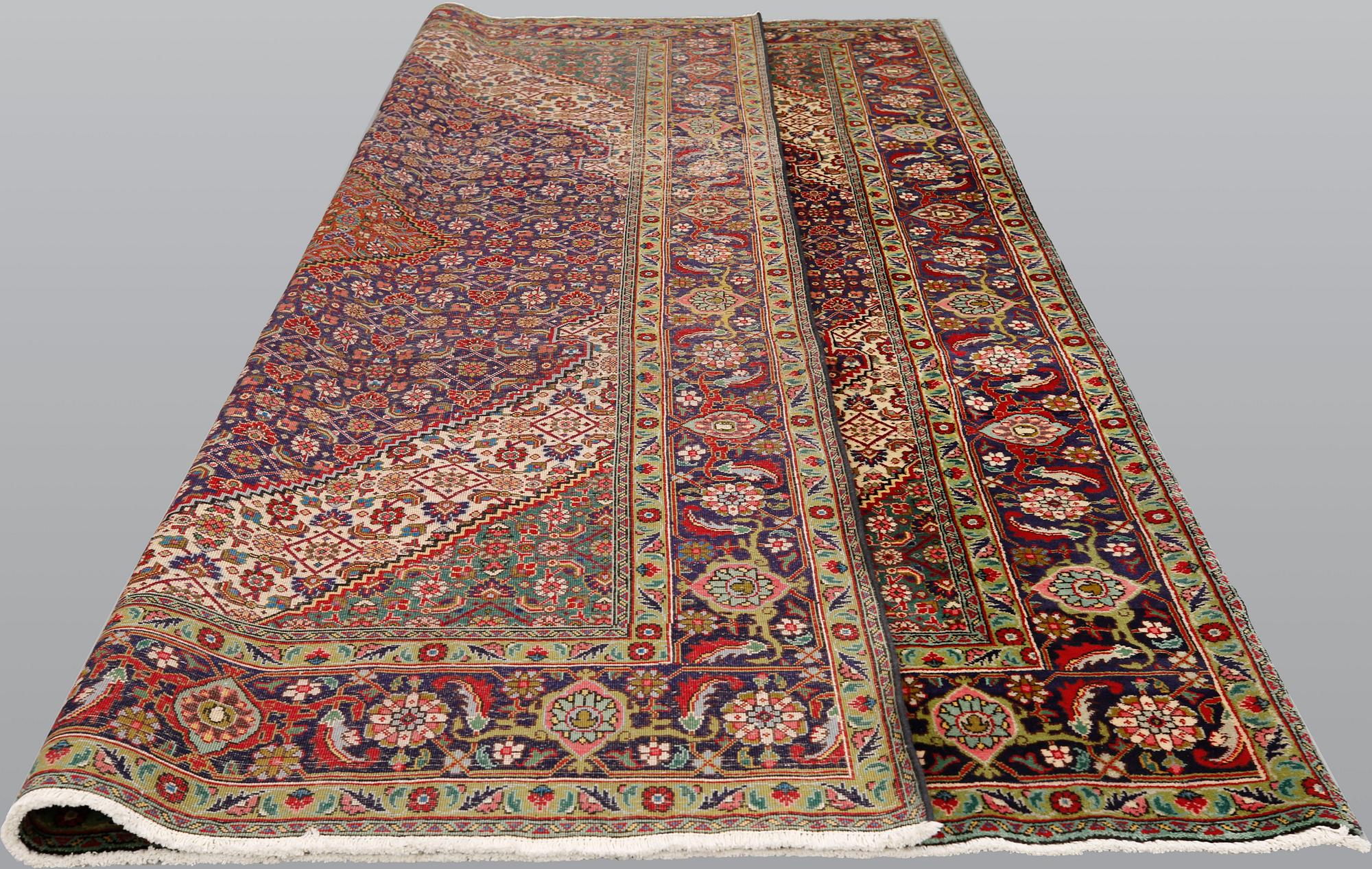 A Tabriz carpet, approximately 360 x 255 cm.