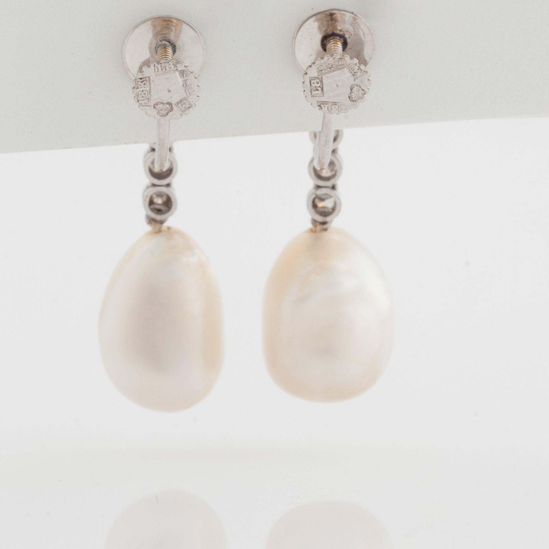 A pair of probably natural pearl and diamond earrings. Total carat weight of diamonds circa 0.54 ct.