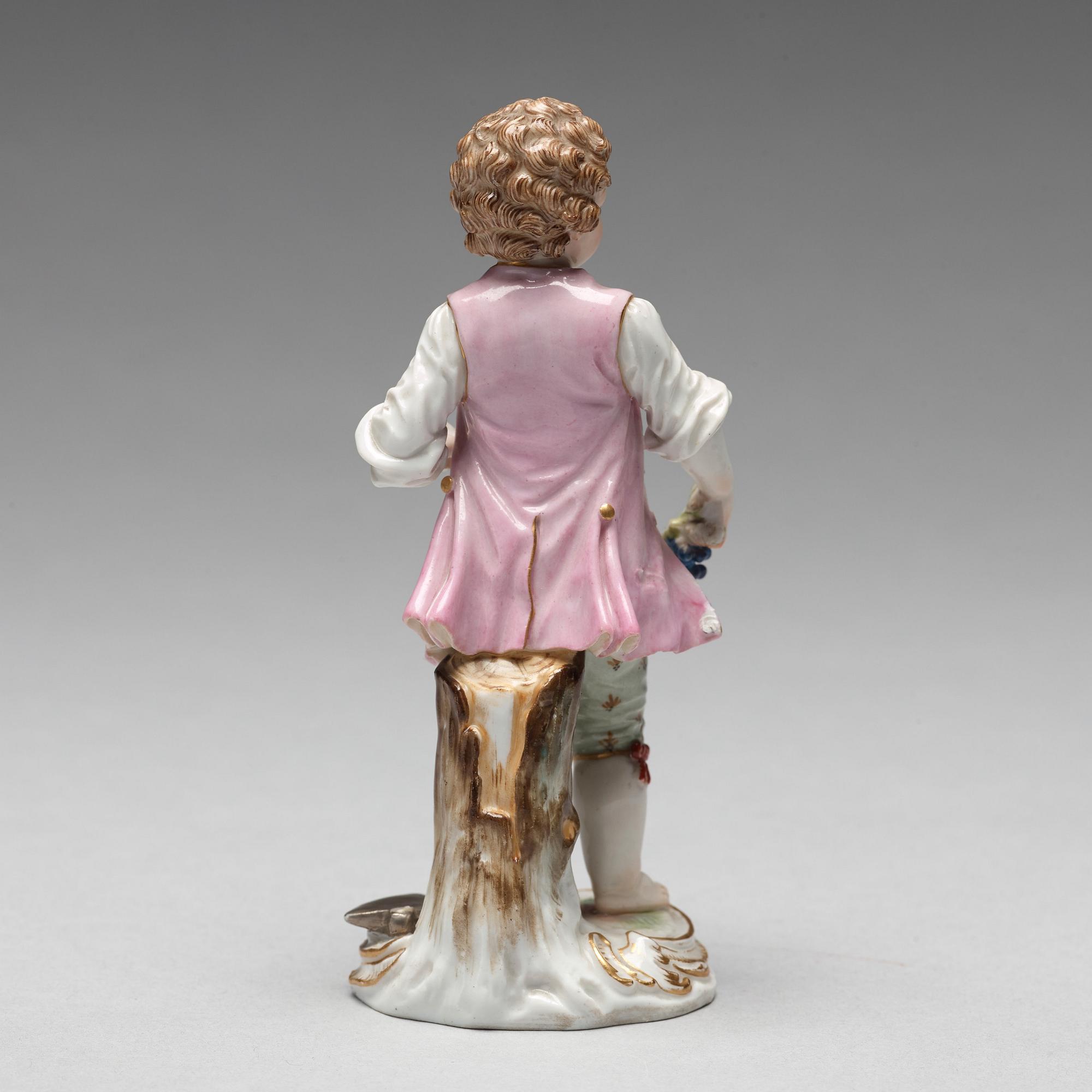 A Meissen figure of a young boy with grapes, 1890's.