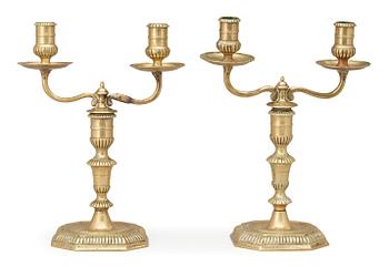 A pair of Swedish Baroque early 18th century bronze two-light candelabra.