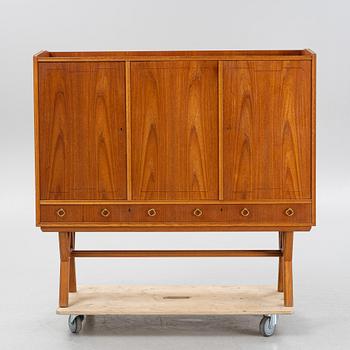 A teak-veneered mid 20th century sideboard.