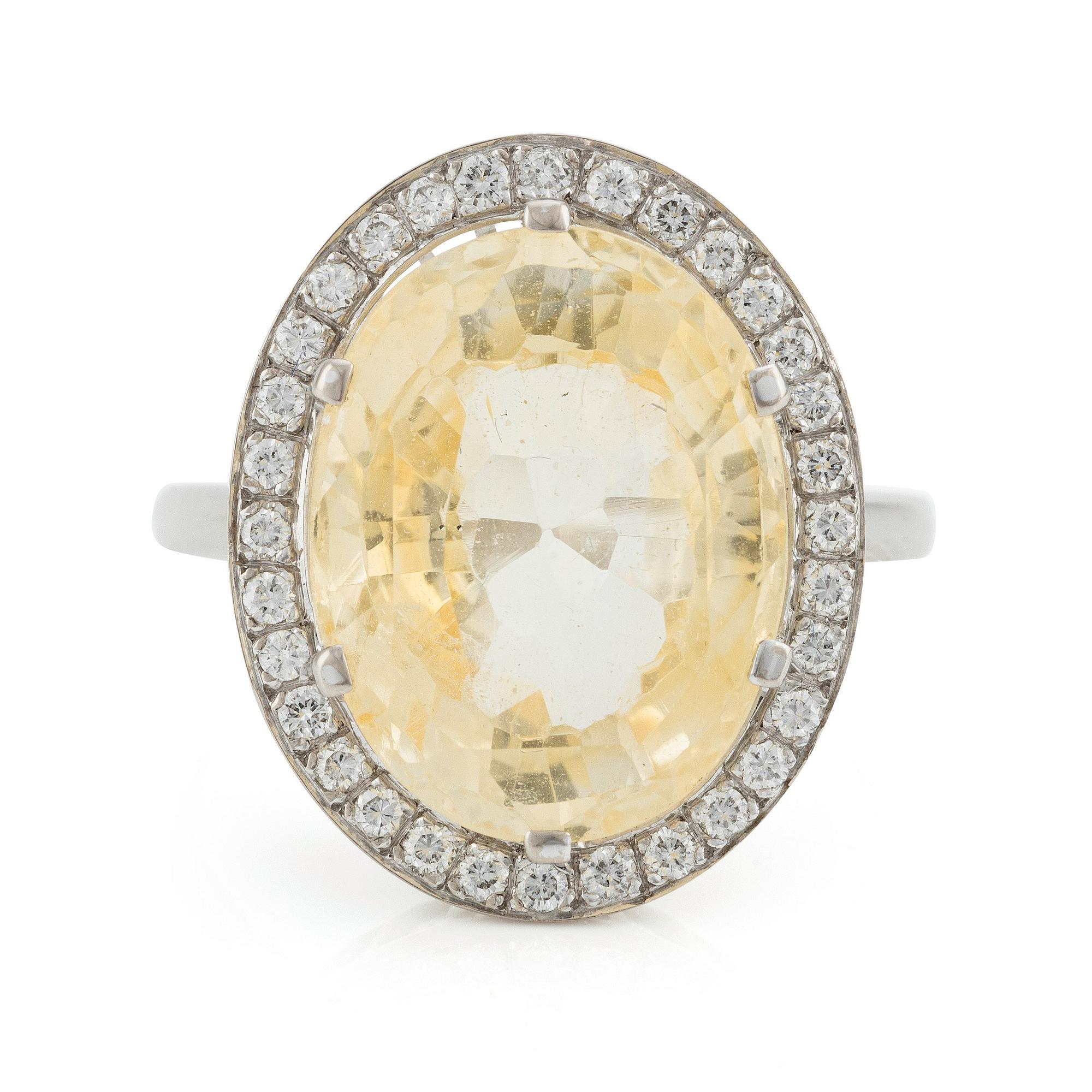 An 18K white gold W.A Bolin ring with a yellow sapphire and round brilliant-cut diamonds. Stockholm 1986,