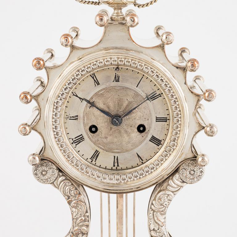 A silver-plate table clock, Empire, mid 19th century.