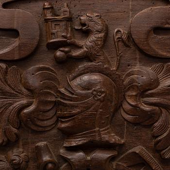 An 18th century carved oak crest.