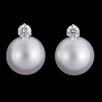 1306. A pair of cultured South sea pearl, 13,3 mm, and diamond earrings, tot. 0.60 cts.