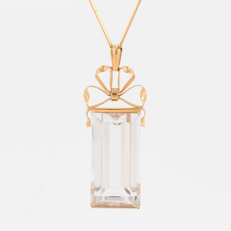 A chain and a pendant set with step-cut quartz.
