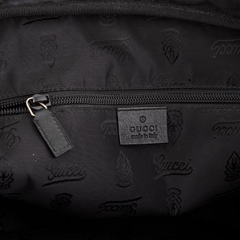 Gucci, a monogram leather bag/laptop-bag.