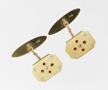 512. A pair of gold, ruby and diamond cuff links.