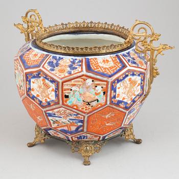 A Japanese plant pot with brass mounts, late 19th century.