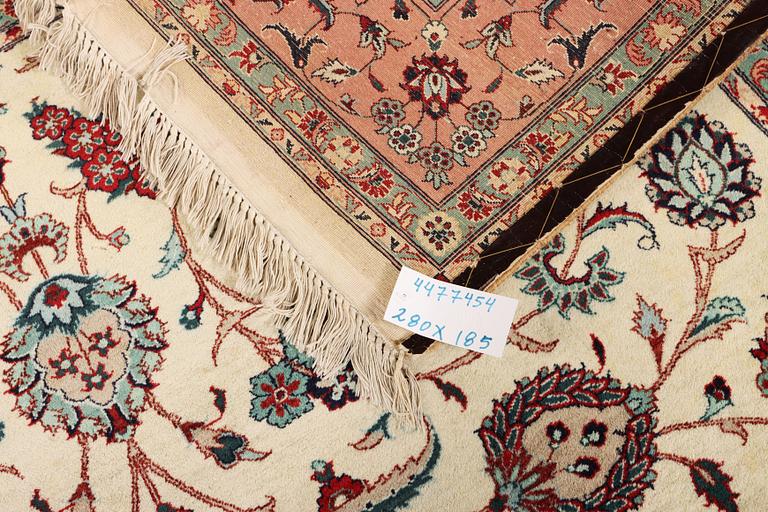 An oriental silk carpet, a. 280 x 185 cm.