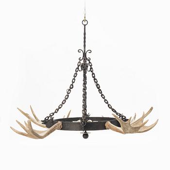 A moose horn and cast iron chandelier from around 1900.