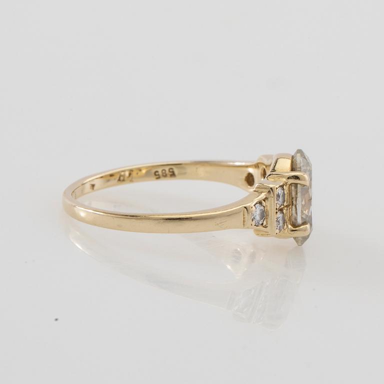 Ring 14K gold with an oval faceted diamond approximately 1.23 ct and round brilliant-cut diamonds.