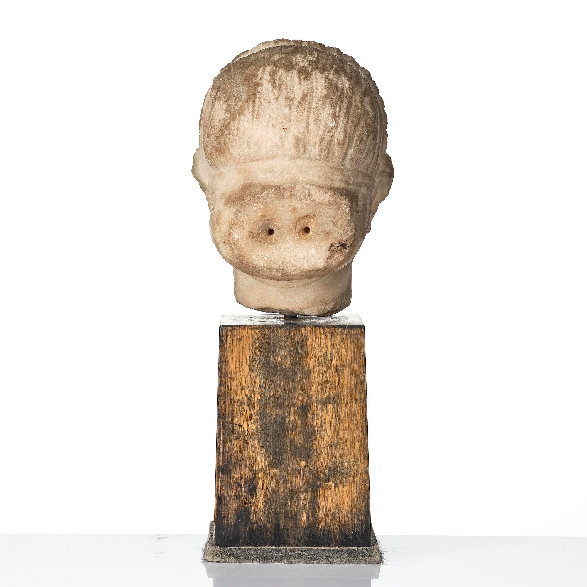 A Greek marble head of a deity wearing a Dionysiac fillet, Hellenistic style presumably 16th century.