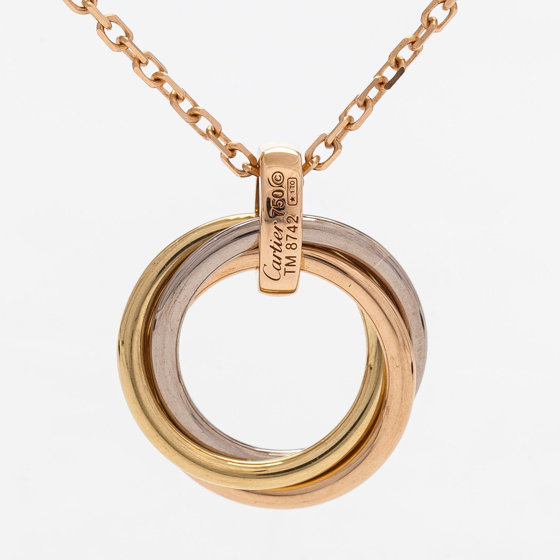 Cartier, an 18K gold 'Trinity Pendant' necklace with brilliant-cut diamonds.