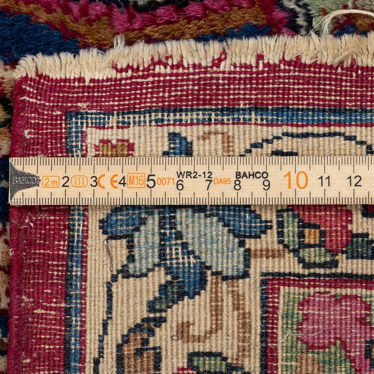 A Kerman carpet, c. 365 x 265 cm.
