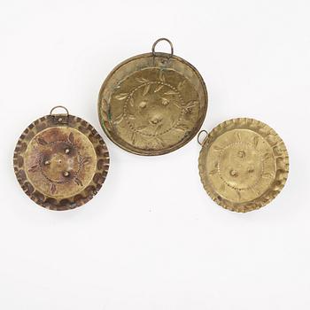 three brass candle holders from the 18th century.