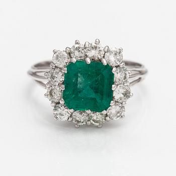 An 18K white gold ring with diamonds ca. 1.56 ct in total and an emerald ca. 2.70 ct according to certificate.