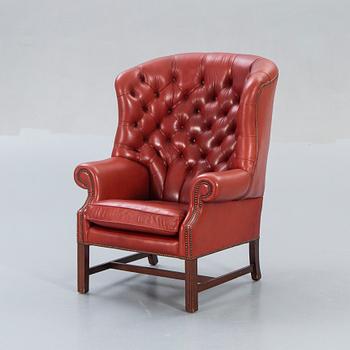 An English leather wing back chair later part of the 20th century.