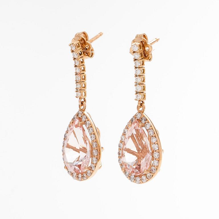A pair of 18K gold earrings, with pear-cut morganites and diamonds.