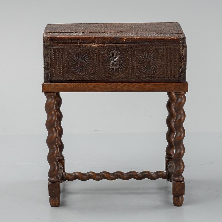 A late 18th or early 19th century wooden box on a stand from early 20th century.