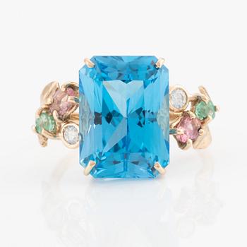 Ring, cocktail ring with large blue topaz, tourmalines, emeralds, and brilliant-cut diamonds.