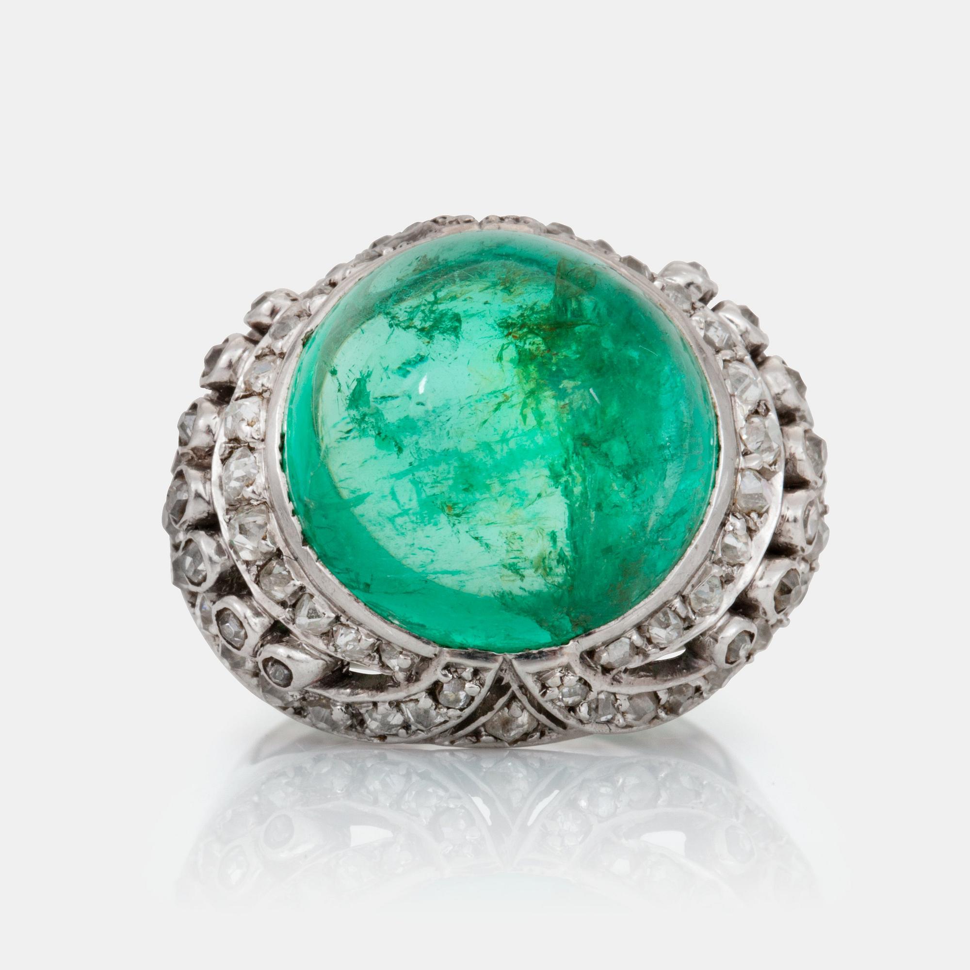A cabochon-cut emerald and old-cut diamond ring.
