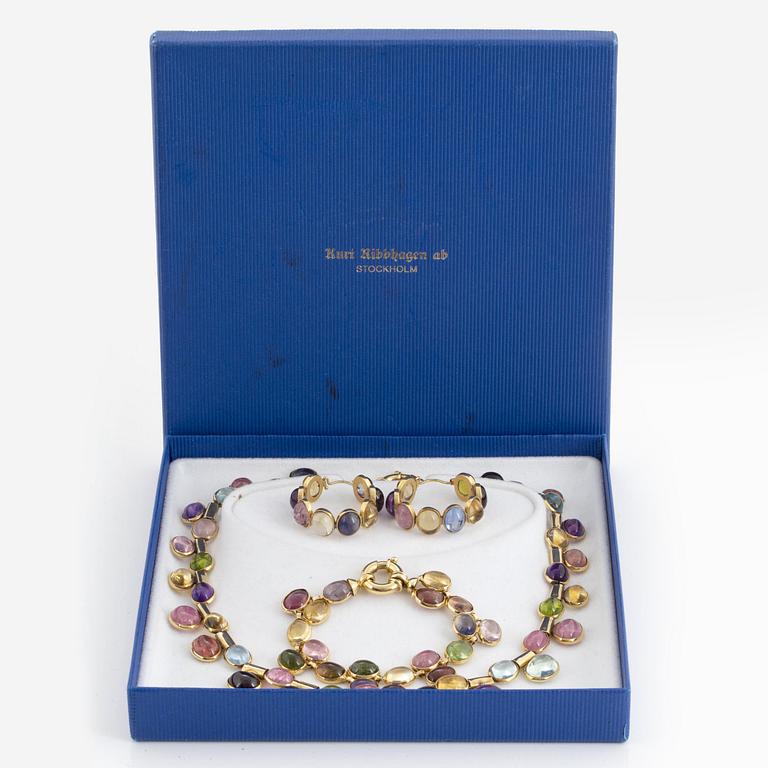 A set with necklace, earrings and bracelet with cabochon-cut multi coloured stones and gold.