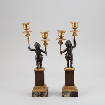 A pair of bronze empire style candleabra, 20th century.