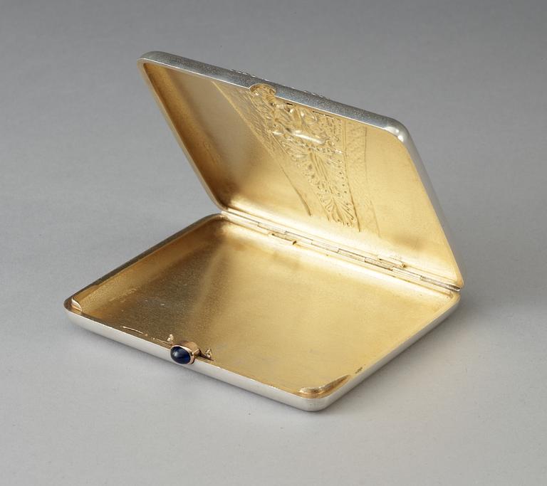 A Russian parcel-gilt cigarette-case, makers mark of Ivan Chlebnikov, Moscow 1908-1917. Imperial Warrant.
