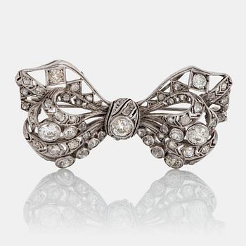 851. A silver bow brooch set with old-cut diamonds.