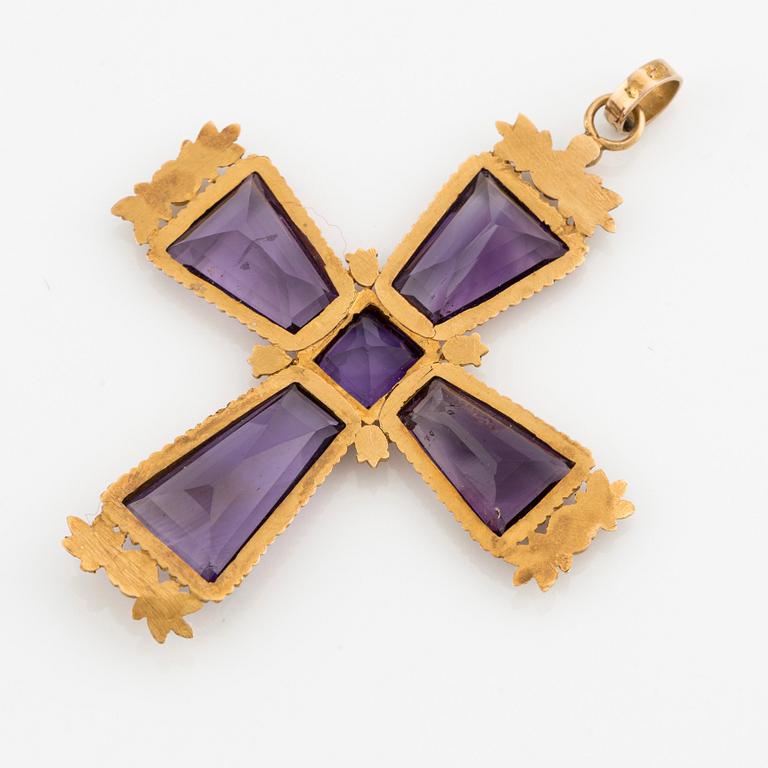 An 18K gold cross with amethysts with a 23K gold chain.