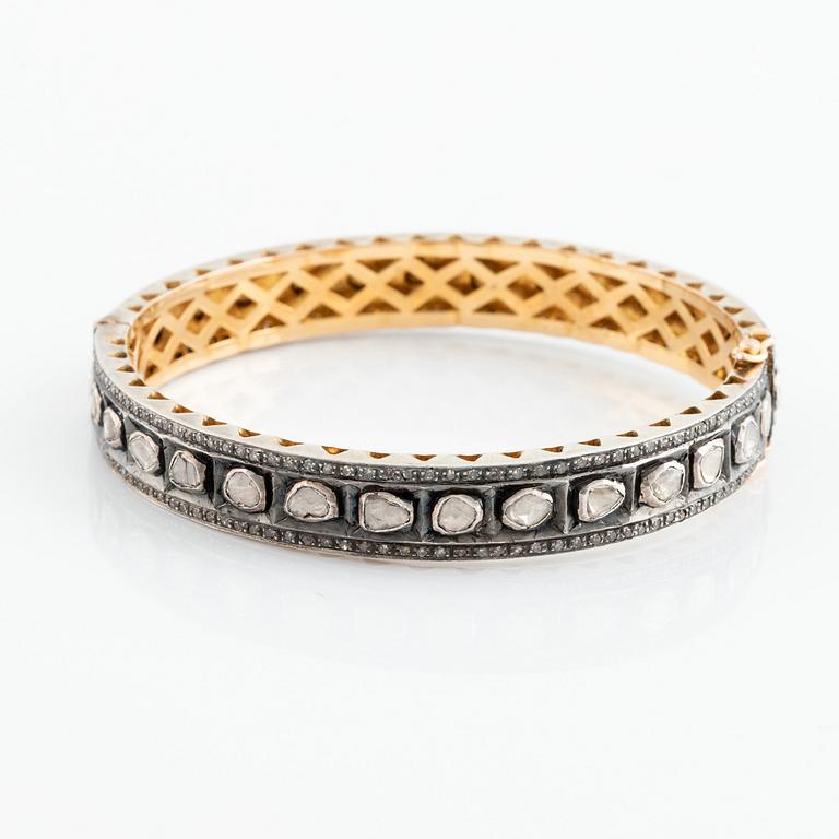 A faceted diamond bangle.