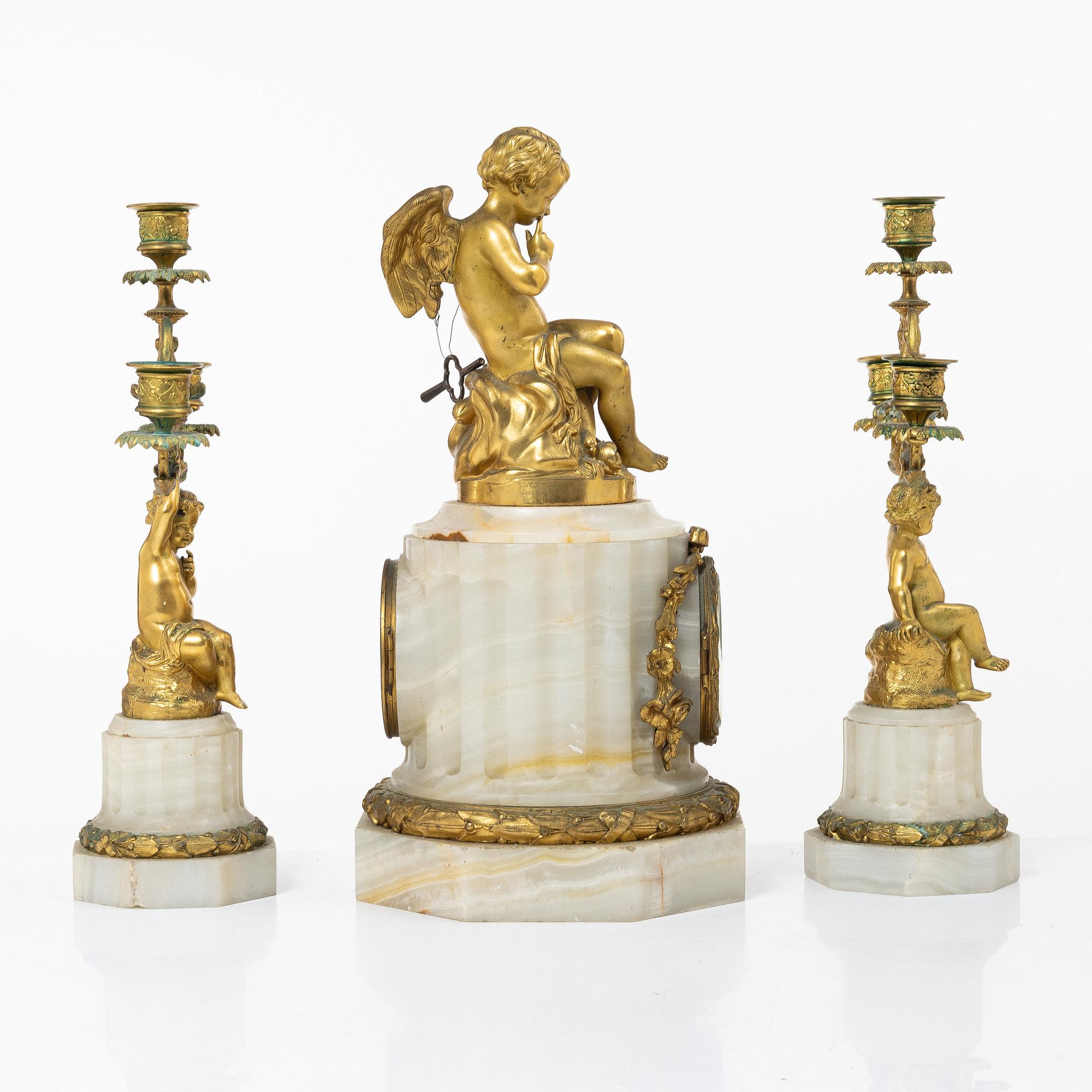A three piece table garniture, circa 1900.