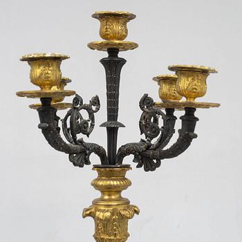 A pair of French Empire-style patinated and gilt bronze five-light candelabra, later part 19th century.