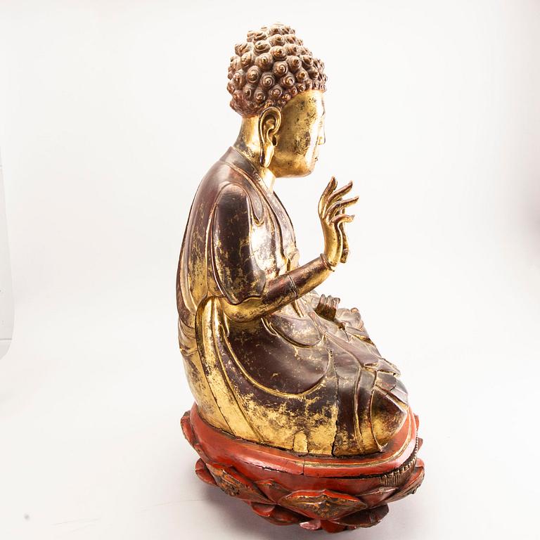 A large gilt and lacquered figure of a seated buddha, Qing dynasty, 19th Century.