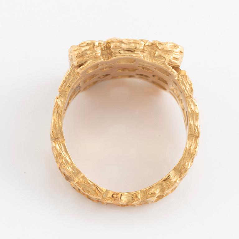 A Gilbert Albert ring in 18K gold.