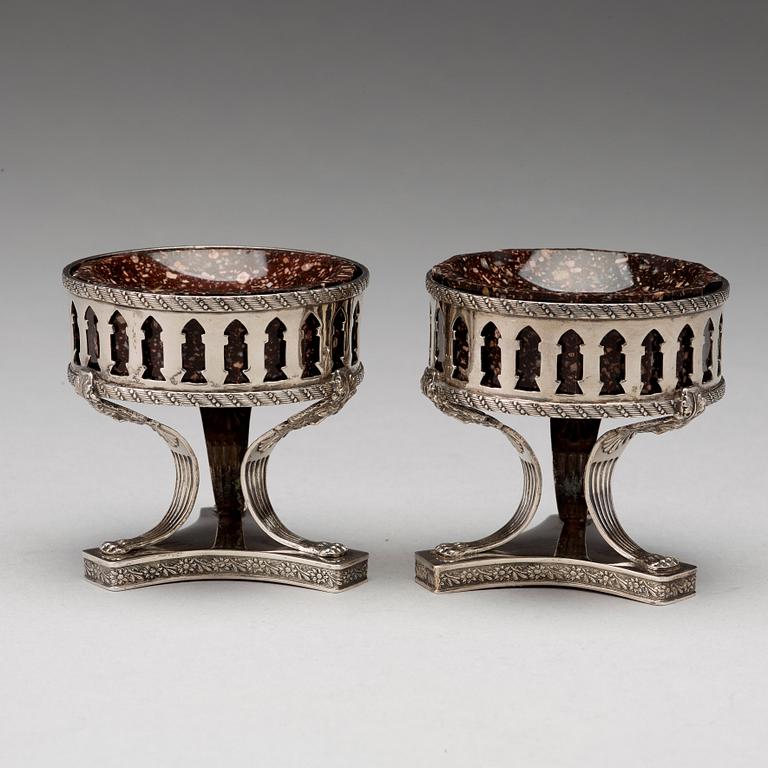 A pair of Swedish 19th century porphyry and silver salt-cellars, silver with mark of Gustaf Folcker, Stockholm 1823.