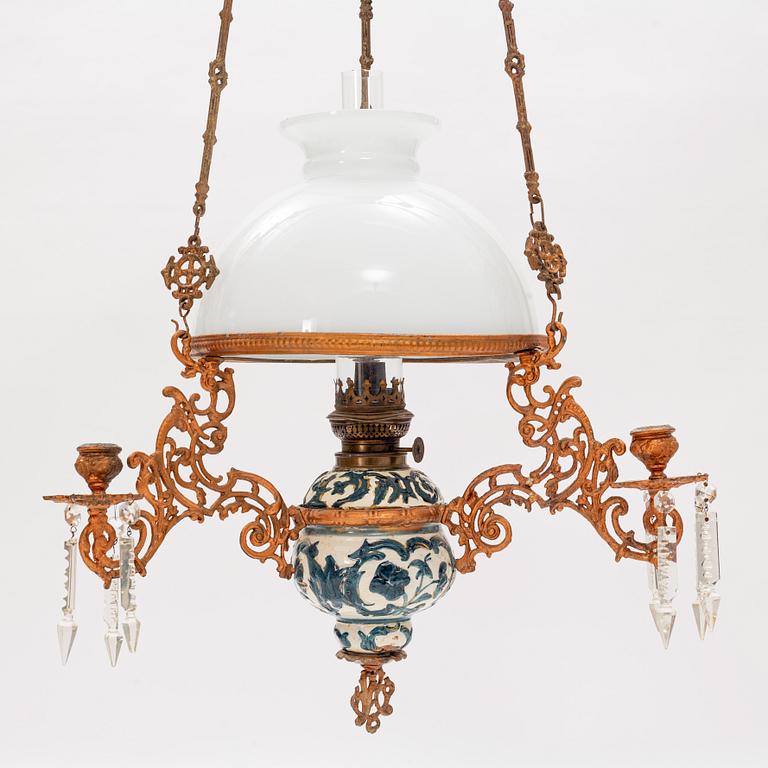 A ceiling carosene lamp, circa 1900.