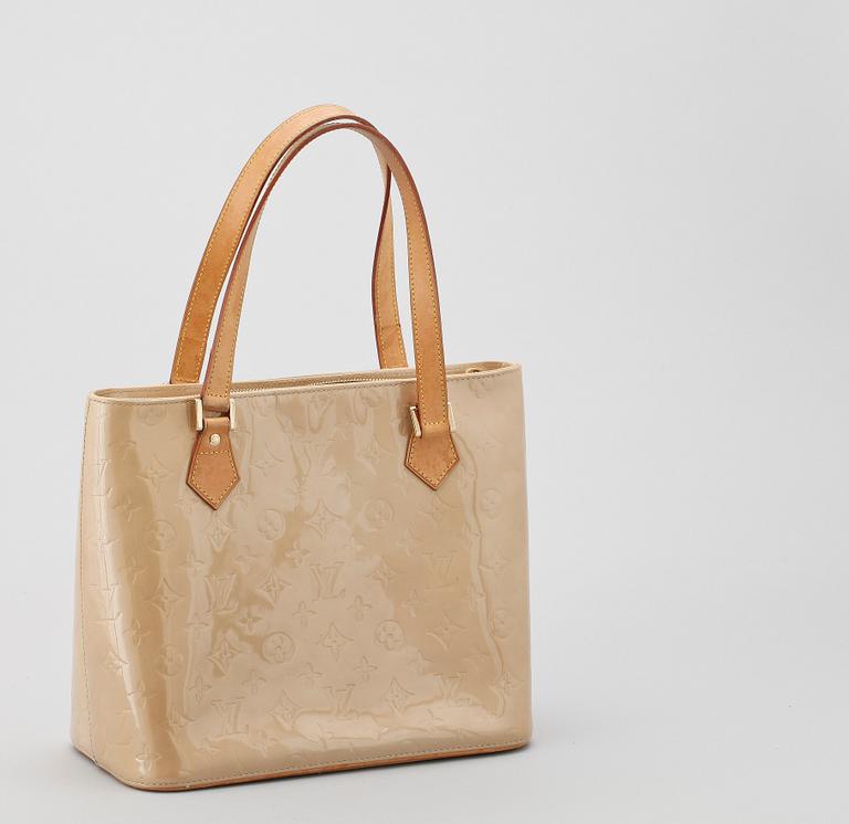 A beige monogram vernis handbag by Louis Vuitton.