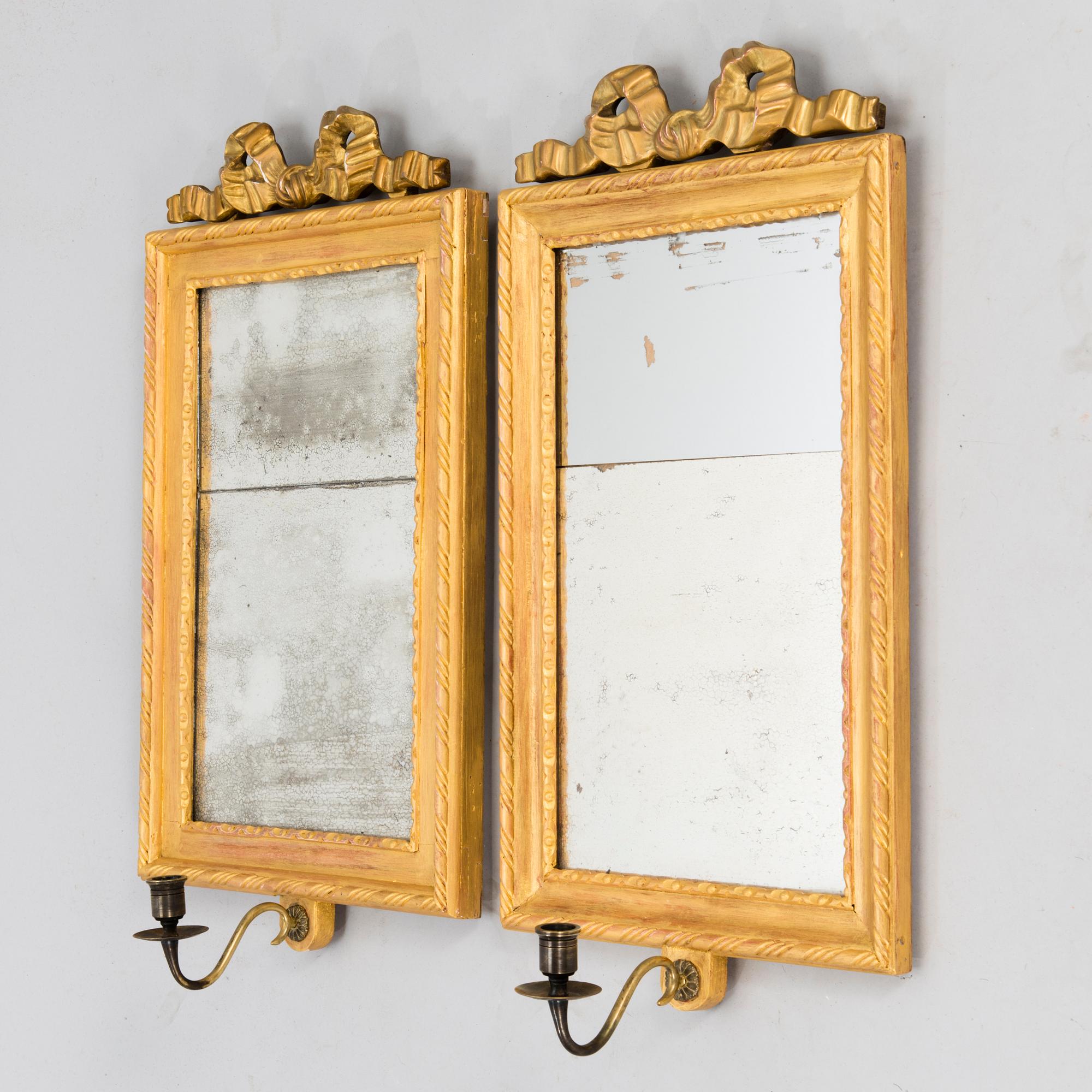 A pair of mirrored wall sconces from the latter half of the 20th century.