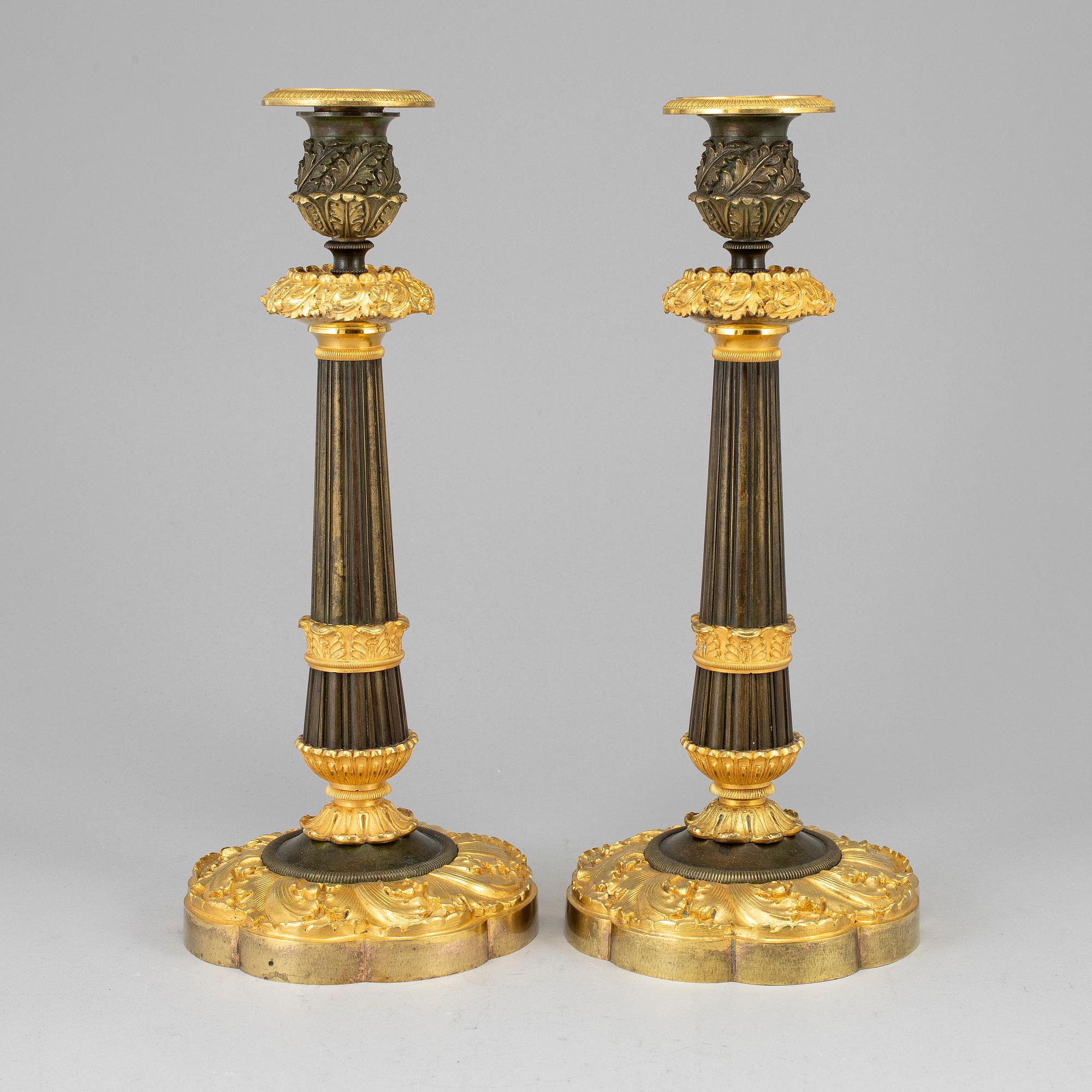 A pair of ormolu late empire candlesticks, mid 19th century.