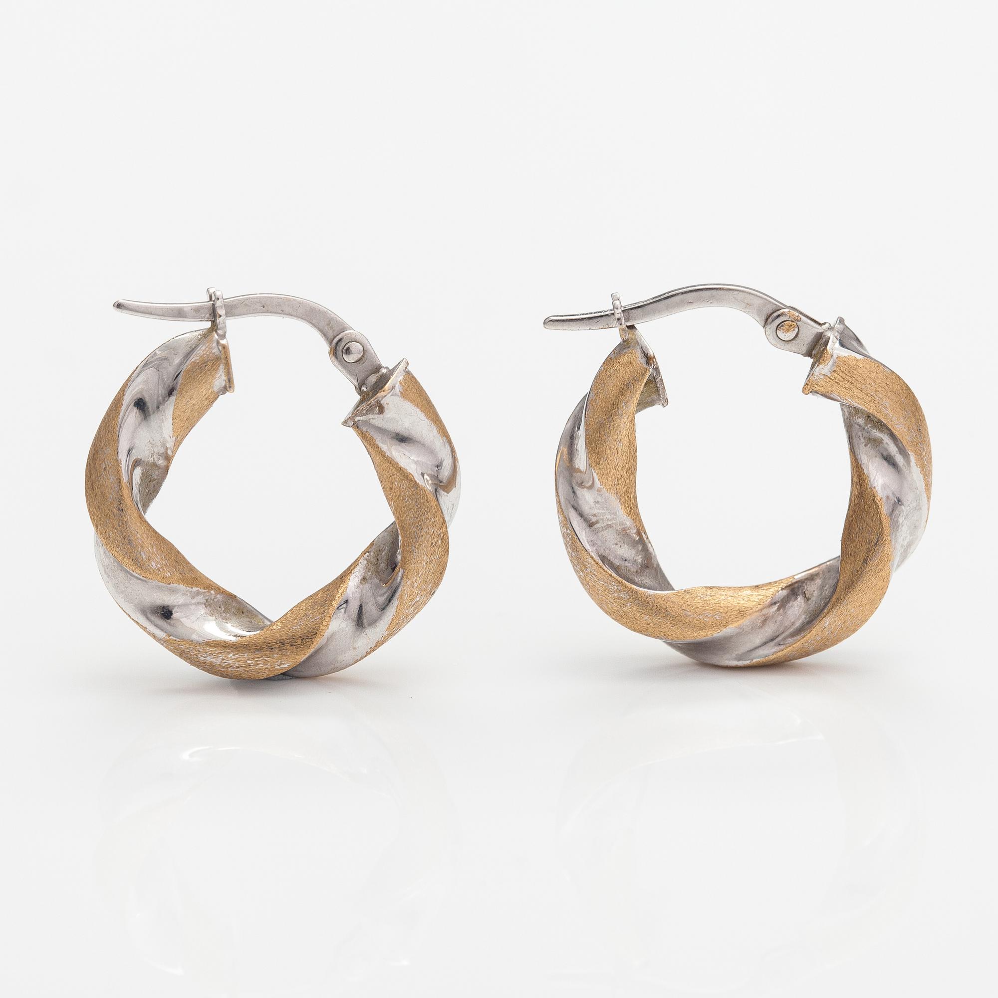 A pair of 14K white and yellow gold earrings. Unoaerre, Italy.