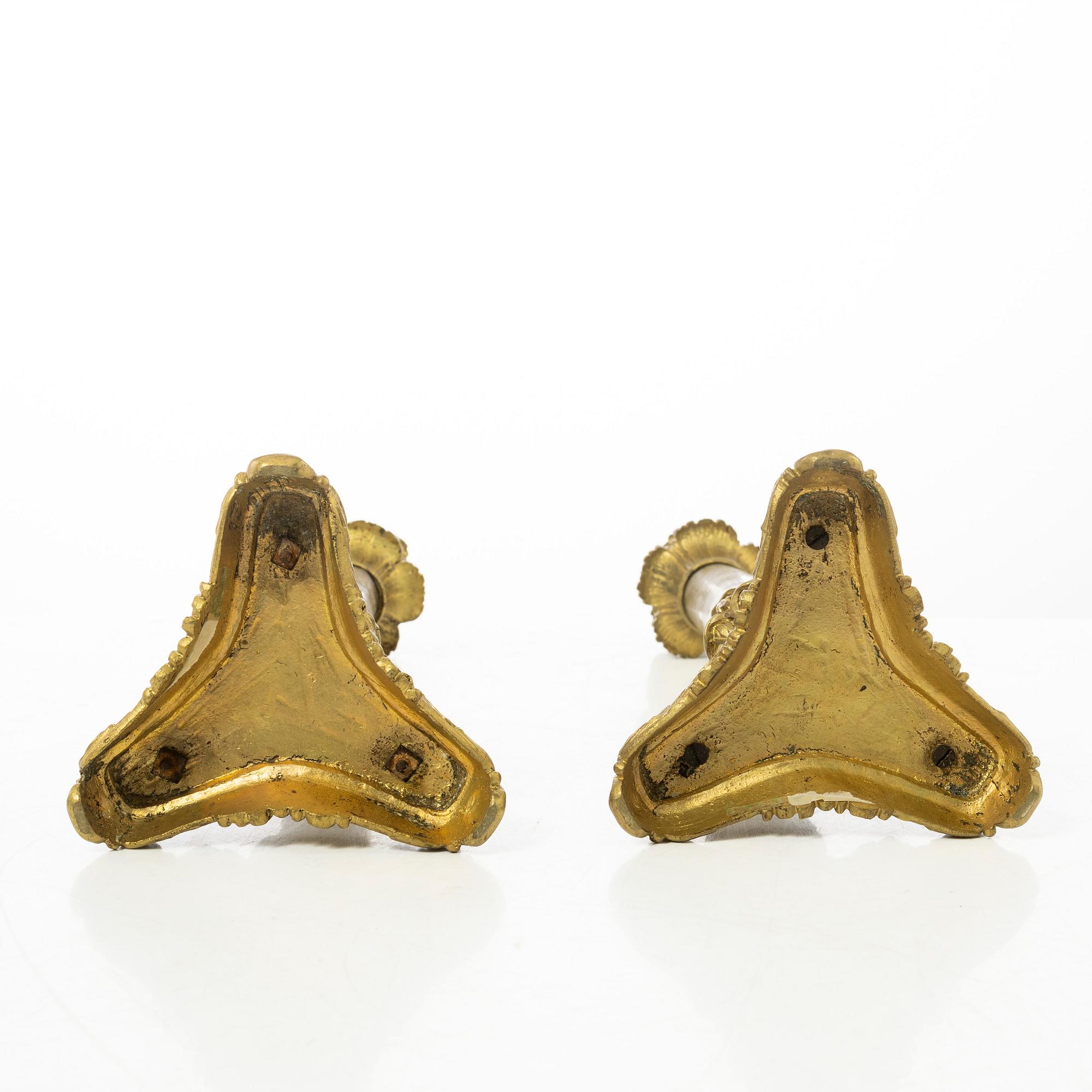 A pair of brass and bronze late Empire candle sticks, mid 20th century.