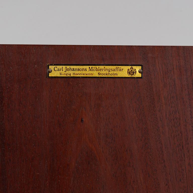 A mahogany bedside cabinet by Carl Johanssons Möbleringsaffär, around the year 1900.