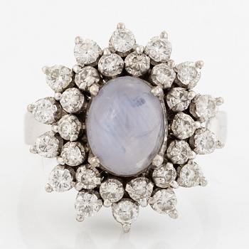 Ring, 18K white gold with cabochon-cut star sapphire and brilliant-cut diamonds.