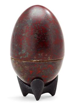 944. A Hans Hedberg faience egg on an iron base, Biot, France.